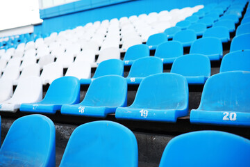 Plastic chairs in the stands of a sports stadium. Cheer on the stands of the stadium.