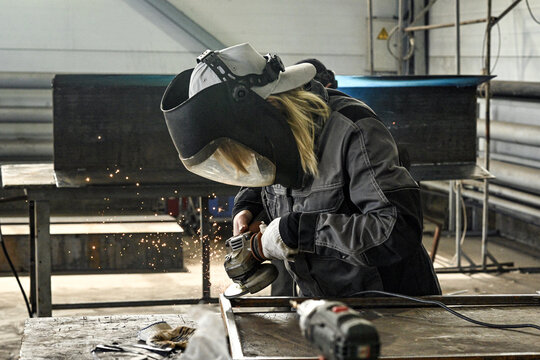 Manufacturing industry plant factory welding turner milling machine operator welder girl woman sparks grinder