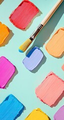 Colorful paint swatches arranged in a grid pattern, a paintbrush with a vibrant blue tip is positioned above the swatches