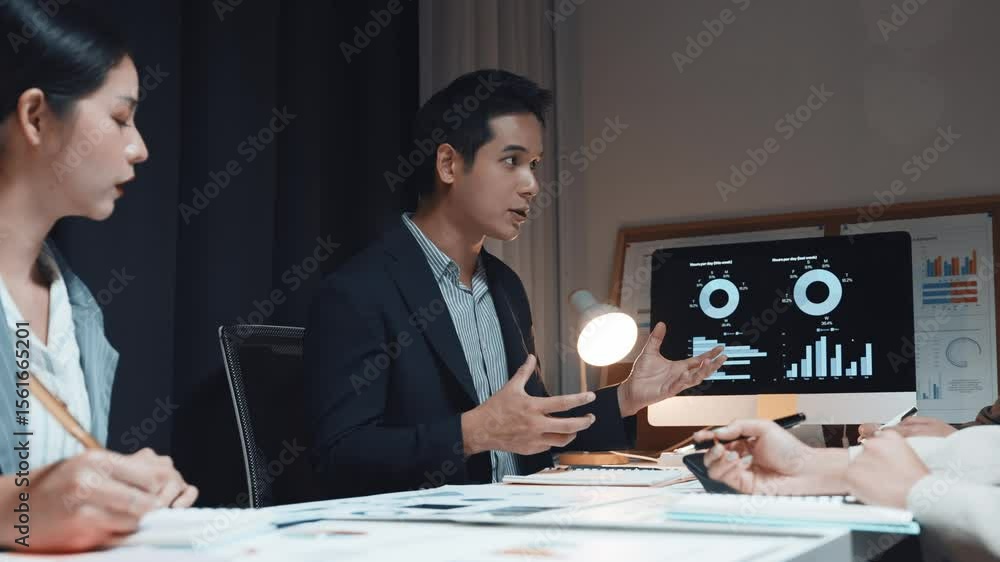 Poster business professionals collaborating late at night, analyzing financial charts and data on computer 
