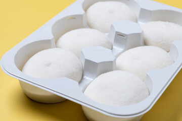 Japanese Coconut ice cream mochi on yellow background