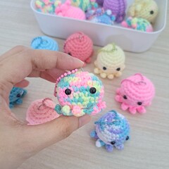 Crocheted baby octopus in hand - crochet keychain
