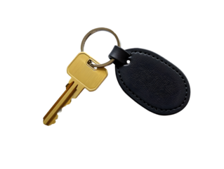 Closeup Studio Shot of Gold Brass Metal Key with Black Leather Keyring Oval Tag on white  Background