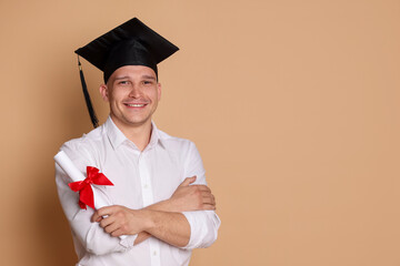 Happy student with diploma after graduation on beige background. Space for text