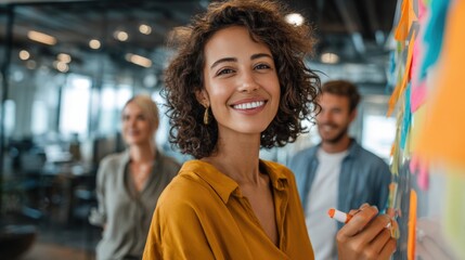 Cheerful diverse group of young adults brainstorming and collaborating in modern office environment.
