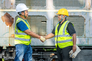 Two engineers shake hand in rail Industrial meeting cooperation, engineers team in Construction site handshake Workers for Deal Agreement Partnership in Engineering Field