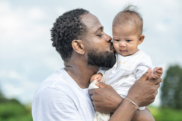 Man is kissing a baby