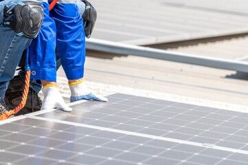 A worker installing solar panels on a roof.