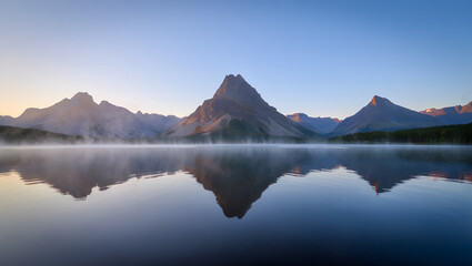 Serene Sunrise: Misty Mountain Lake Reflection, Calm Waters, Majestic Peaks, Tranquil Landscape Photography