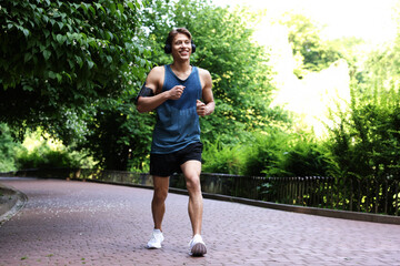 Sporty man with headphones running in park