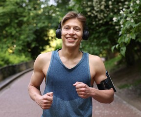 Sporty man with headphones running in park
