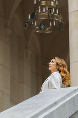 Woman, Chandelier, Palace - A woman in a white dress standing in a palace hallway with a chandelier...
