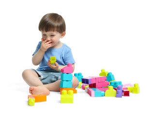 Cute little boy playing with building bricks on white background