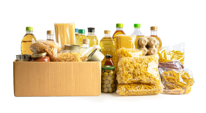 Foodstuff for donation, storage and delivery. Various food, pasta, cooking oil and canned food in cardboard box.