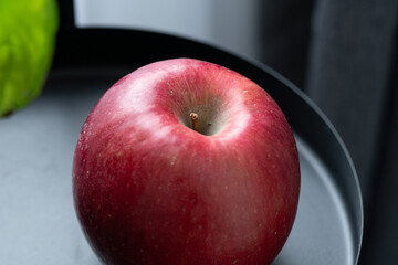 Red apple on a black metal table