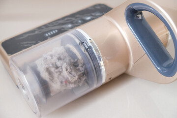 Close-up of dust dirt sucked up by handheld vacuum cleaner.