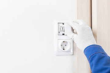 close up of electric light switch installation on white wall