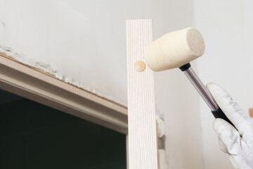 rubber mallet, hammers the plastic plug into the end of the door
