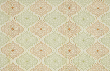 Old wallpaper on the wall. Old wallpaper for texture or background.