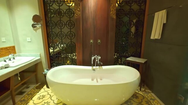 A high ceramic bathroom is installed in the spacious bathroom of all-suit of the luxury hotel, the interior is decorated with natural materials. Room tour, introductory video