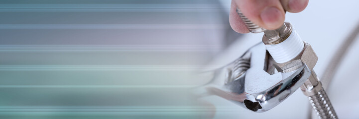 Plumber screwing plumbing fittings; panoramic banner