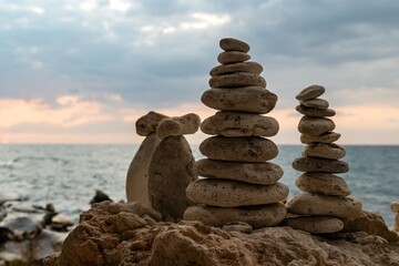 Stone Stacks Beach Sunset - Three stone stacks on a beach at sunset.
