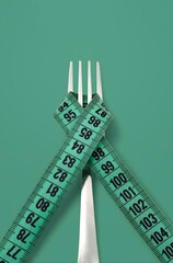 Top view of a fork wrapped with a green measuring tape, isolated on green background.
