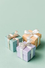 Pastel gift boxes isolated on light green background.