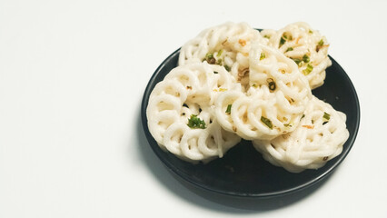 Crispy White Crackers on Black Plate, Asian Cuisine Snack