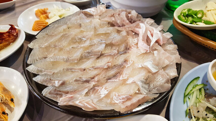 Korean Raw Fish Platter (Hwe) with Side Dishes on Traditional Table