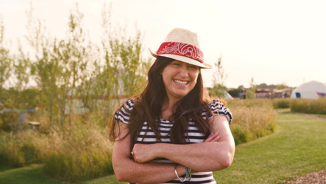 Portrait Of Smiling Mature Woman Visiting Yurt Campsite In Countryside