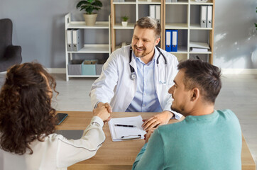 Obraz premium Doctor meeting, congratulate consulting happy couple patients in fertility clinic, offering help, giving medical advice, professional clinician talking to husband, wife, planning pregnancy, test check