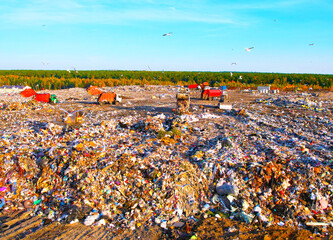 Garbage truck unloads rubbish in landfill, aerial view. Landfill waste disposal. Garbage dump with...
