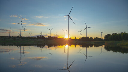 Aerial view of powerful Wind turbine farm for energy production on beautiful cloudy sky at...