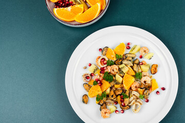 Plate of delicious fruit salad with seafood.