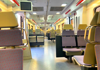 Сhairs in cabin of carriage of a passenger high speed train. Modern interior of urban railway transport. Armchair seat on european double-decker passenger train. Passenger Salon inside train.