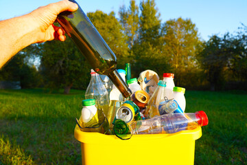 Garbage Sorting. Trash bin bucket. Bottles in Waste container. Glass Waste sorting for Recycling. Glass bottle in trash bin container. Throwing bottles in trash can. Glass bottles in Waste container.