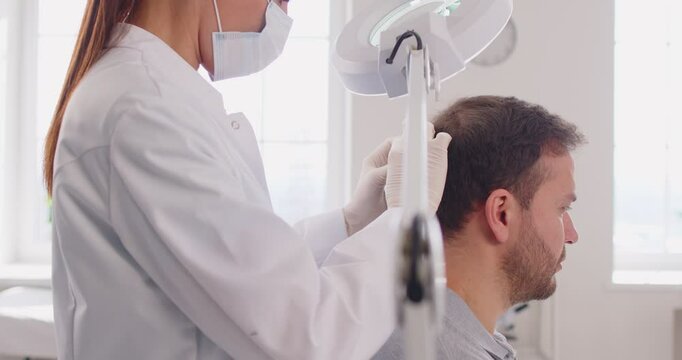 Trichology study of hair and scalp, medical practitioner, dermatologist making male head hair diagnosis and treatment for pediculosis or hair loss, head lice infestation, trichologist clinic treating