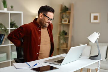Man working from home suffering backache