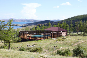 An outdoor swimming pool at a tourist base in a picturesque location