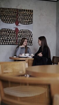 two girls having breakfast in a coffee shop