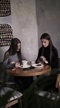 two young girls having breakfast in a coffee shop