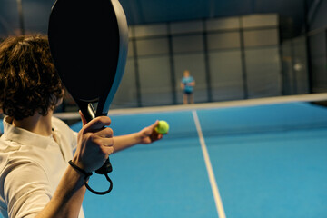 Excitement builds as young sportsmen engage in an intense padel match at the court