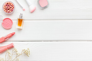 Layout of makeup cosmetic and brown pink shade beauty products, top view