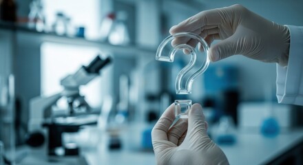 Man in laboratory gloves holding a clear glass question mark. Concept of scientific research, unknown answers, and new discoveries.