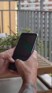 Typing message on smartphone &ndash; vertical video. Close-up vertical shot of fingers typing a text message on mobile phone touchscreen. Communication, chat, texting in portrait 9:16 video format.