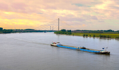 Editorial image of a cargo ship sailing on the Rhine River in Wesel, Germany, with the Niederrhein...