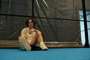 Young sportsman showcases skills on the padel court during an intense game