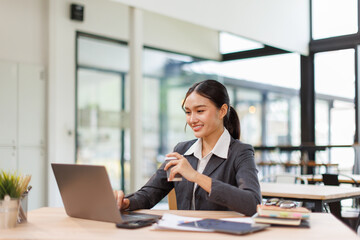Asian business woman accounting holding coffee cup using calculating income-expenditure and...