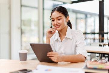 Young asian business woman manager accounting analyst checking bills, analyzing sales statistics...